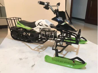 Mały, elektryczny lub zasilany baterią litową skuter śnieżny dla dzieci i dorosłych, do zimowych zawodów na śniegu i jazdy na zewnątrz.