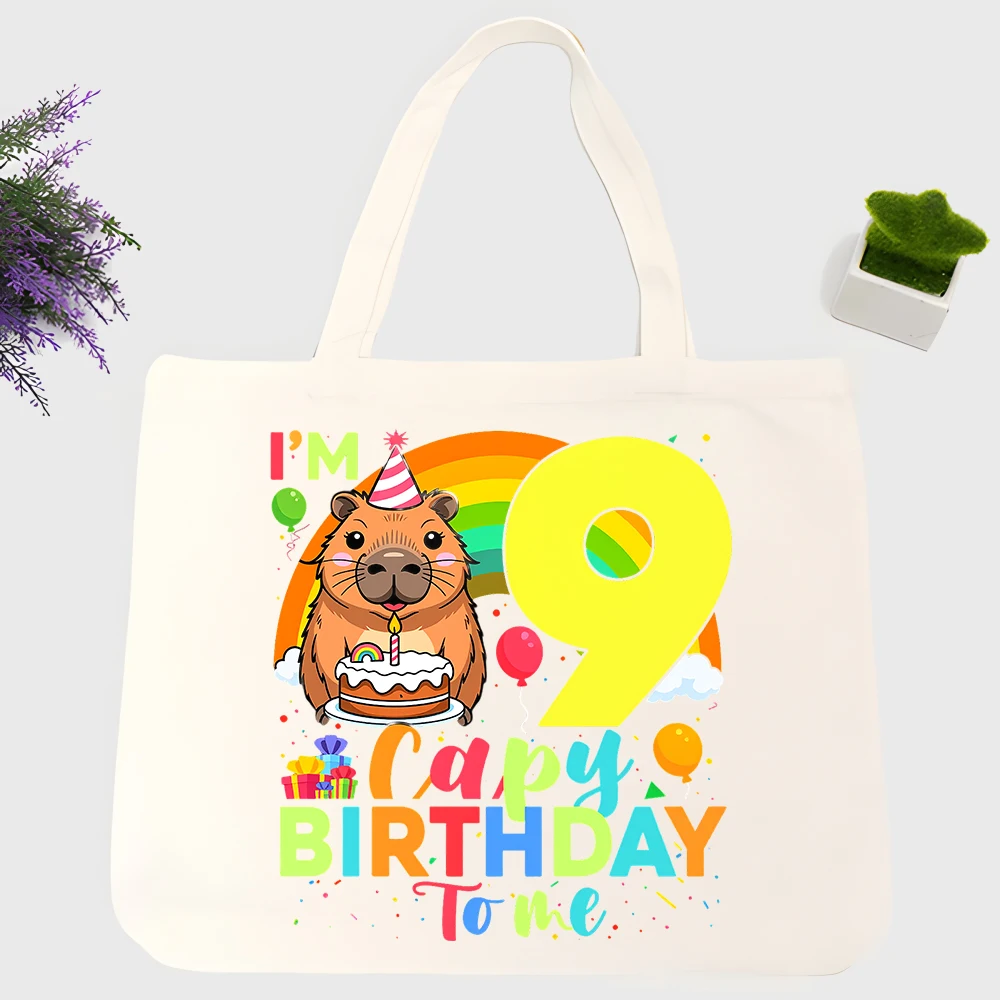 Kids' capybara graphic canvas tote bag with rainbow and birthday elements, perfect for casual party outings and daily use
