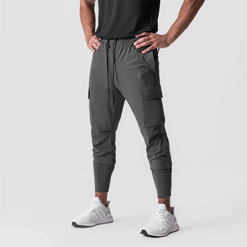 Pantalones deportivos elásticos de secado rápido para hombre, pantalones de entrenamiento deportivos finos y sueltos con bolsillos, ropa de trabajo, diseño 2025