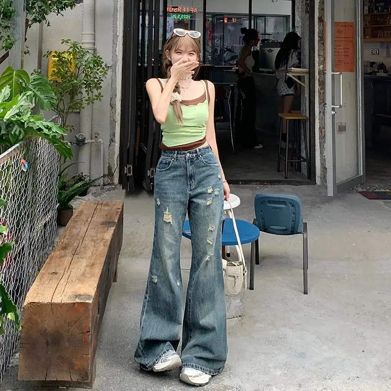 

Irregular holes wear and tear slightly flared jeans high waisted loose wide legged women