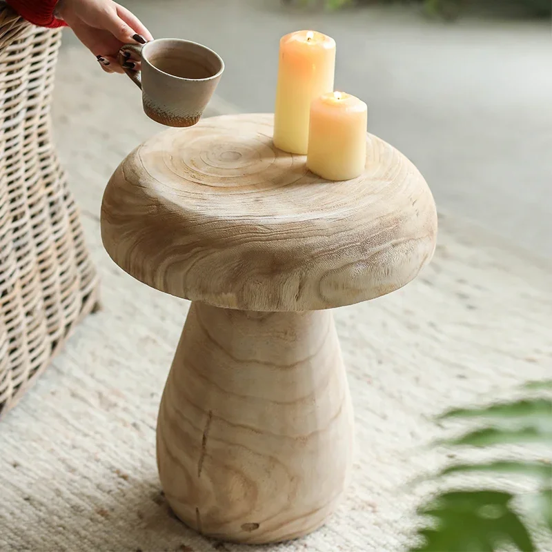 A few solid wood paulownia wood retro living room floor decoration mini small coffee table beside the sofa.