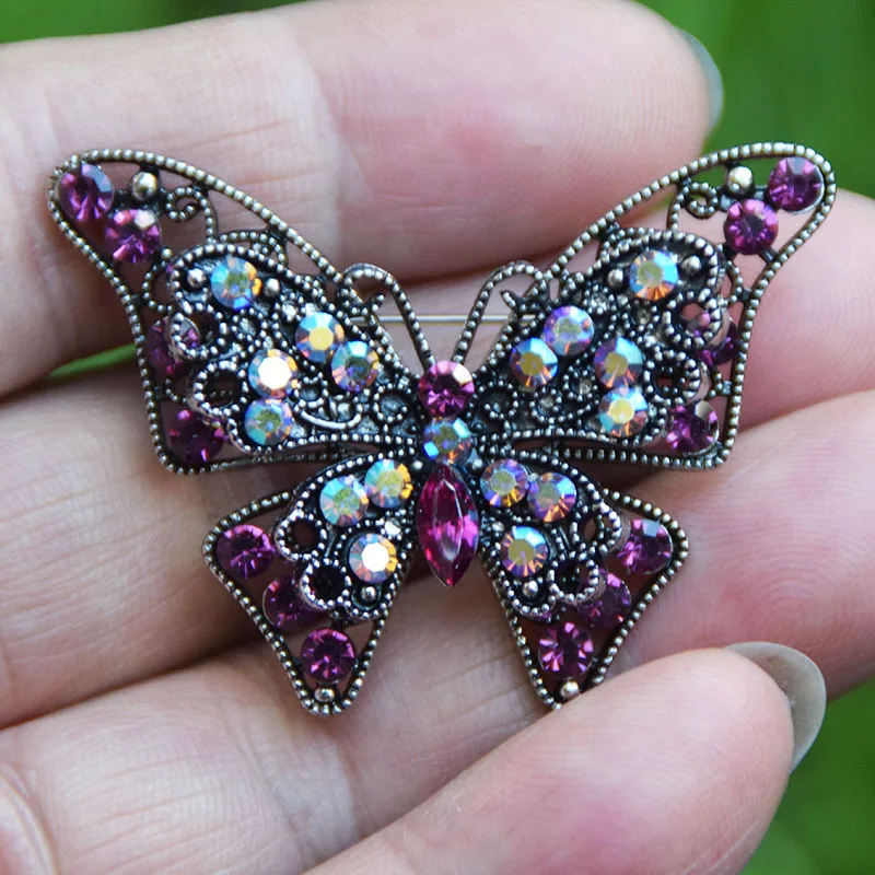 3-D Butterfly Brooch Adorned with Sparkling Purple Rhinestones - May Purple Colored Rhinestone Filigree Butterfly Brooch Pins