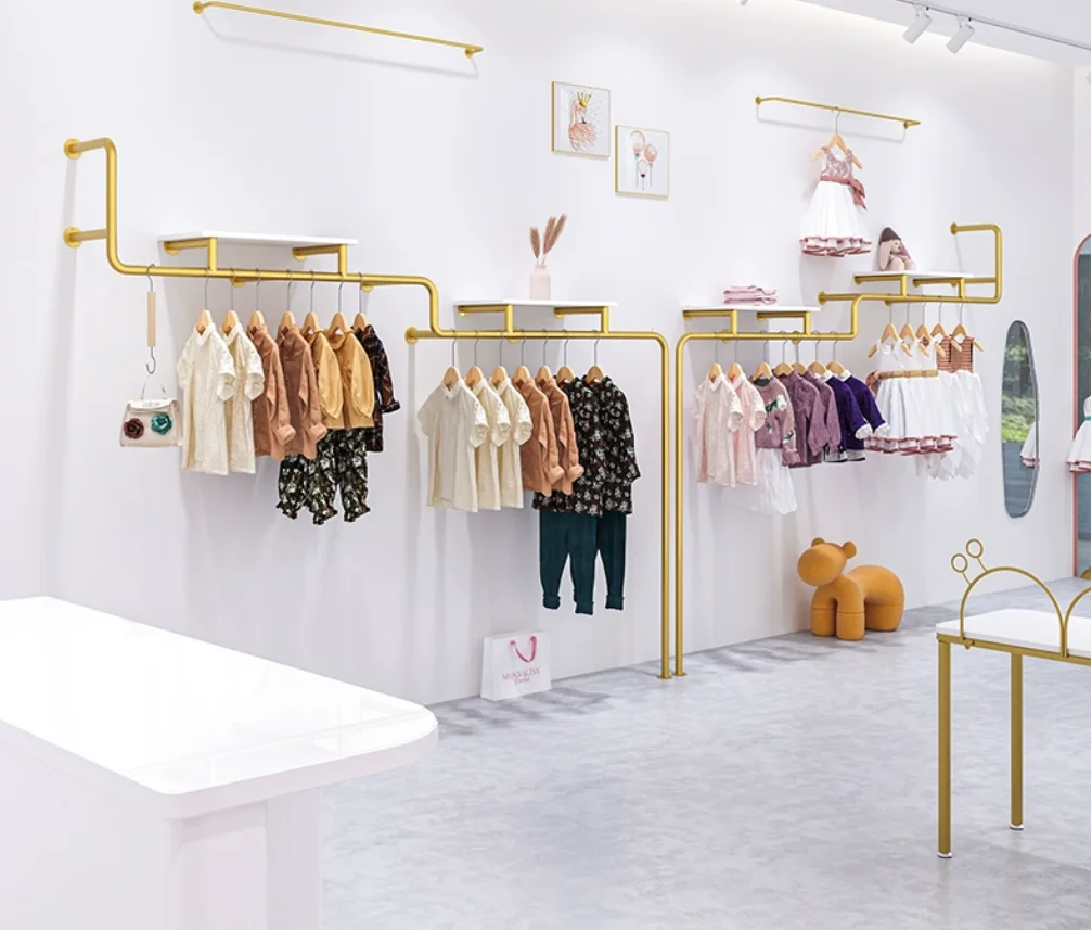 

Children's clothing store shelves display racks on the wall, golden clothing racks hanging on the clothing store wall, hangers