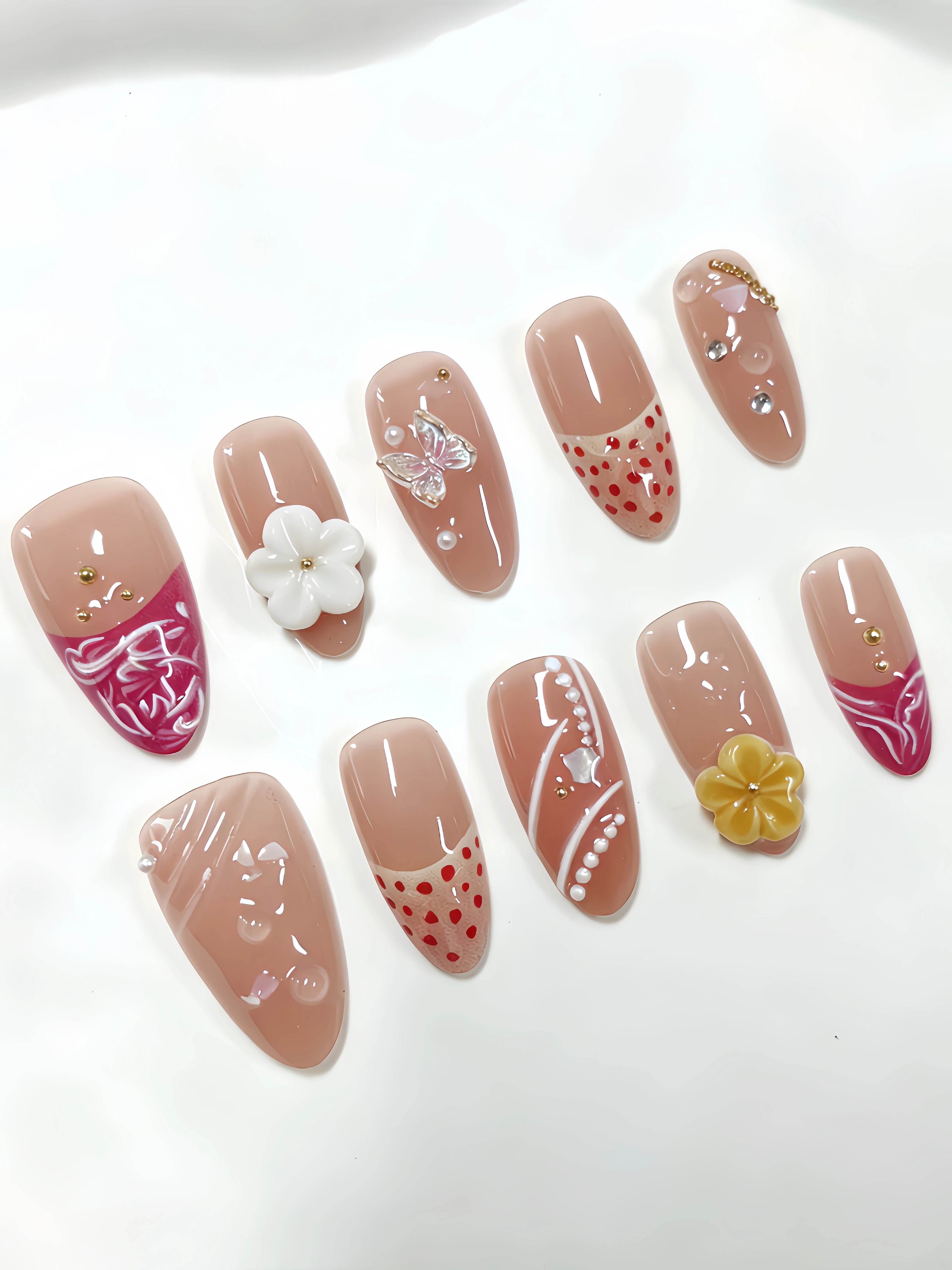 10 Short Almond-Shaped Nail Tips, a Fresh and Simple Style with Main Colors in Apricot, Rose Red, and Orange, Featuring French-Style Sweet Nail Art with Hand-Carved Flowers, Butterflies, Chains, Rhinestones, Gold Beads, Polka Dots, and Silver Foil Embellishments. Suitable for Work, Students, Vacation Season, Beach Photoshoots, Outings, and Dates. Includes One Jelly Glue and One Nail File