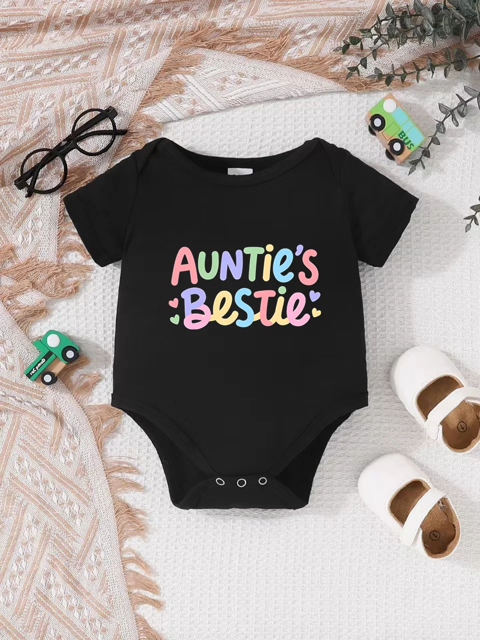 Playful letter-printed baby short-sleeve triangle bodysuit. Button closure for easy dressing
