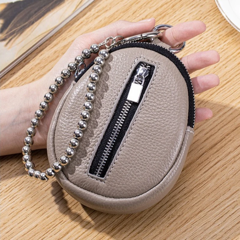 

Новинка 2025 года, кошелек для монет из натуральной кожи, мини-кошелек, женская сумка для хранения наушников с двойной молнией, брендовая маленькая круглая подвесная сумка с подвеской