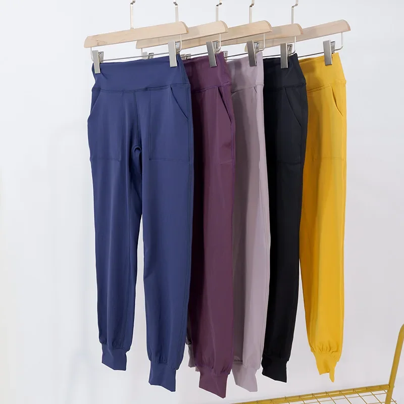 بنطلون يوغا طويل مرن عالي الخصر للنساء مع جيوب خارجية وأصفاد مريحة للكاحل وخصر مرن لصالة الألعاب الرياضية واليوجا