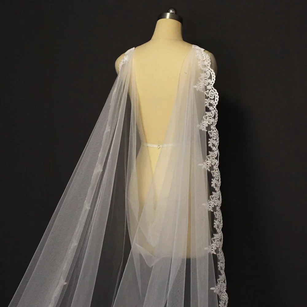 

Customized long bridal wedding cape made of lace measuring 3.5 meters, featuring a Brillo shoulder veil and a nail fish,