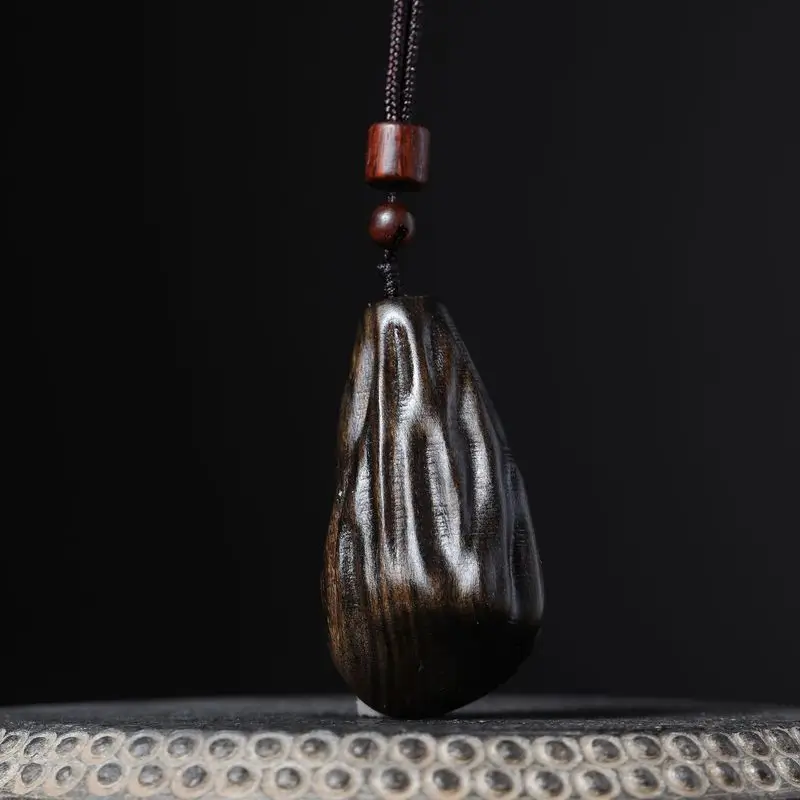 Natural Vietnamese agarwood pendant with insect-carved details, hand-held ornament, decorative piece, and necklace