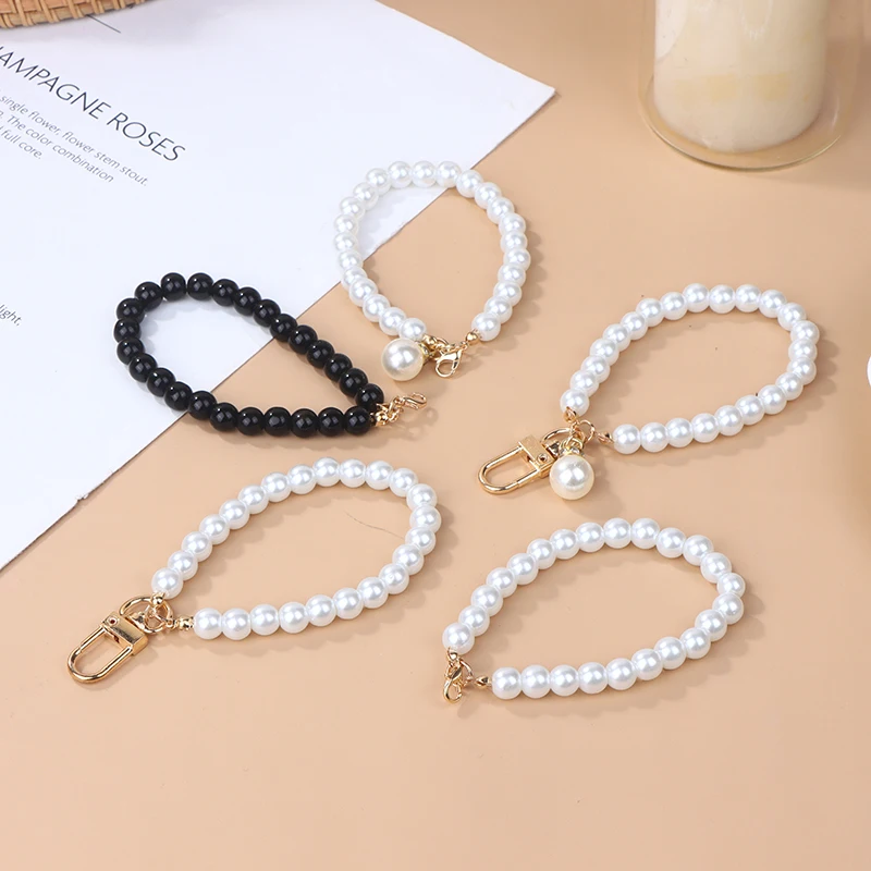 LLavero de perlas de imitación para mujer, colgante de bolso de auriculares, llavero de pulsera con cuentas de perlas, adorno para teléfono móvil