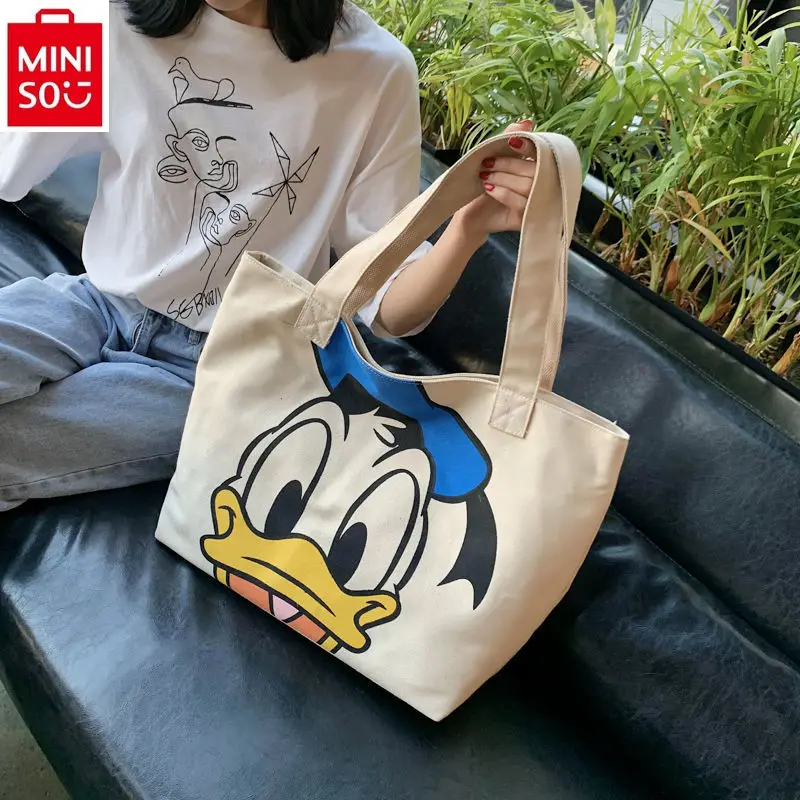 

MINISO Disney Cartoon Large Capacity Donald Duck Mickey Student Shoulder Canvas Bag is simple and versatile