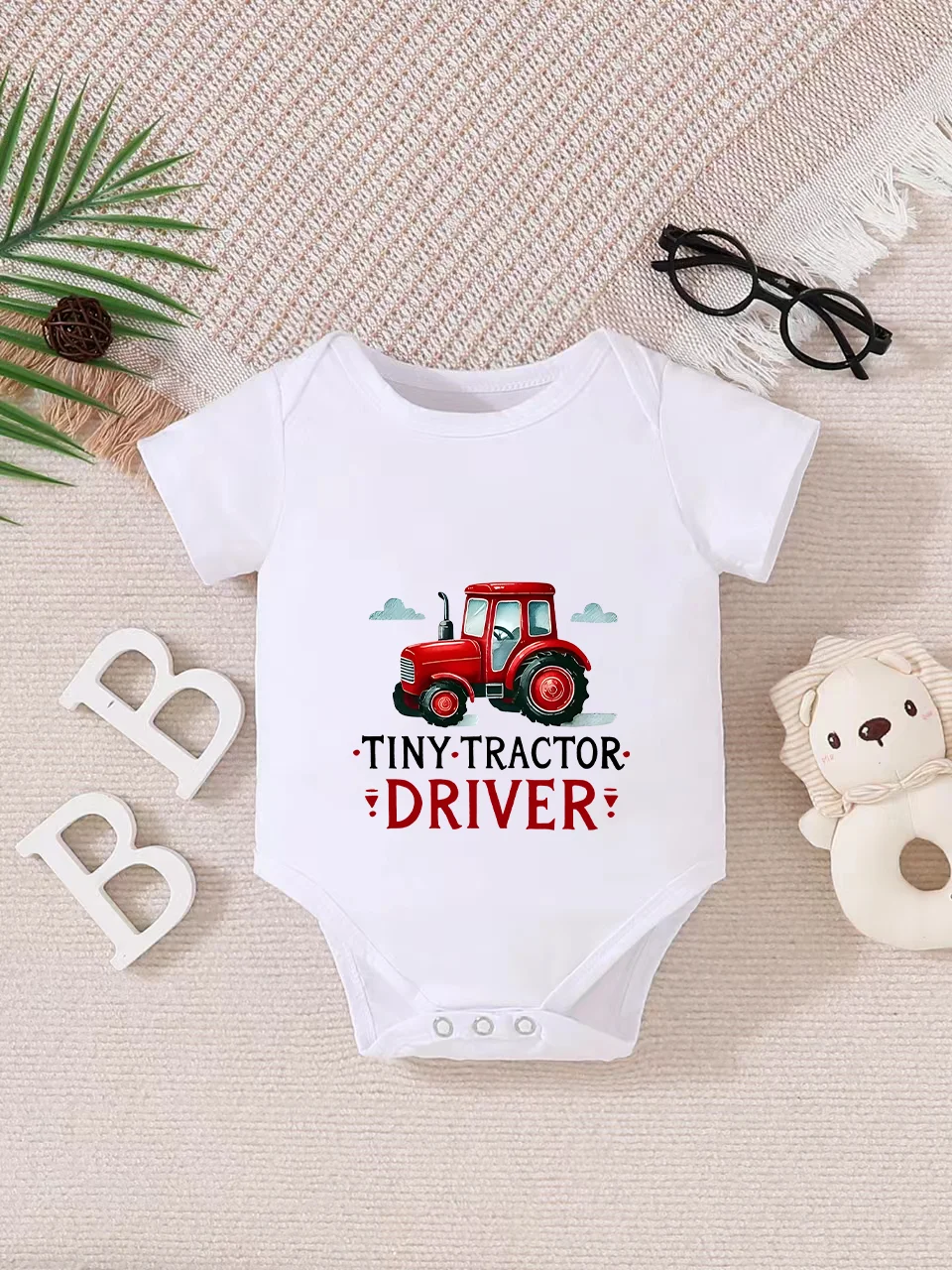Playful letter-printed baby short-sleeve triangle bodysuit. Button closure for easy dressing, machine washable