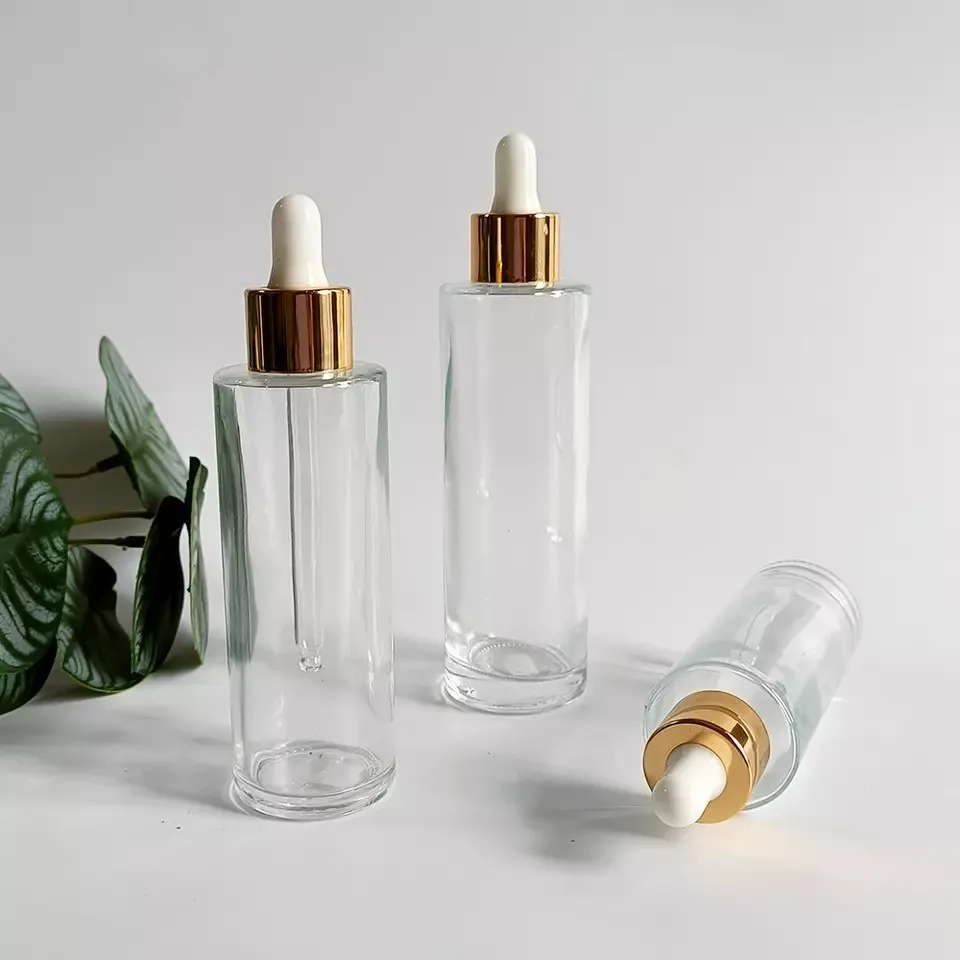 Wholesale 20-100ml Transparent Flat Shoulder Glass Essential Oil Serum Dropper Bottle With Gold Lid Skin Care Emulsion Container