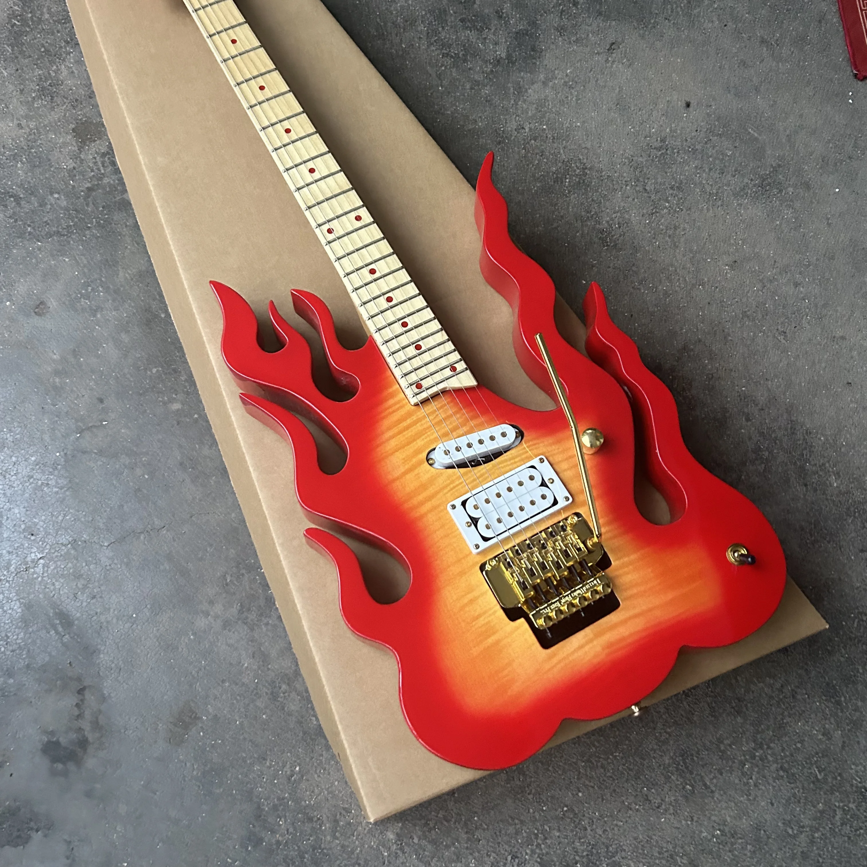 Inventory: New flame guitar, tiger-pattern painted guitar, with a tremolo arm.