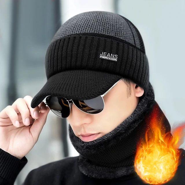 Women's grey and black knitted peak cap with a "JEANS new wear" patch and a matching black neck warmer worn by a model.