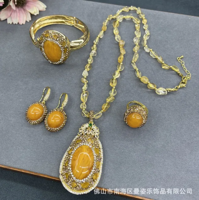 

Live broadcast new beeswax jade inlaid citrine four-piece set medieval point crystal cross-border supply pendant earrings ring