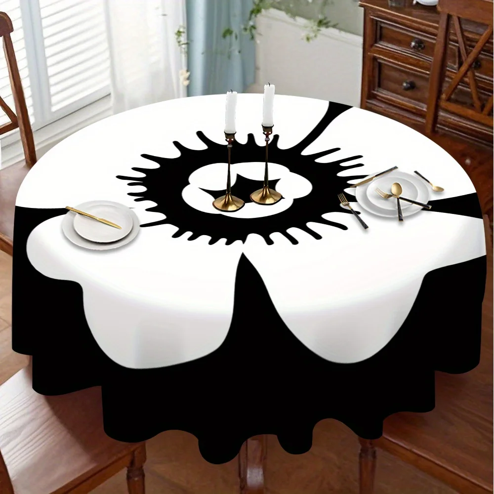 A round tablecloth with a black and white floral pattern, which is perfect for displaying on the kitchen table.zyc
