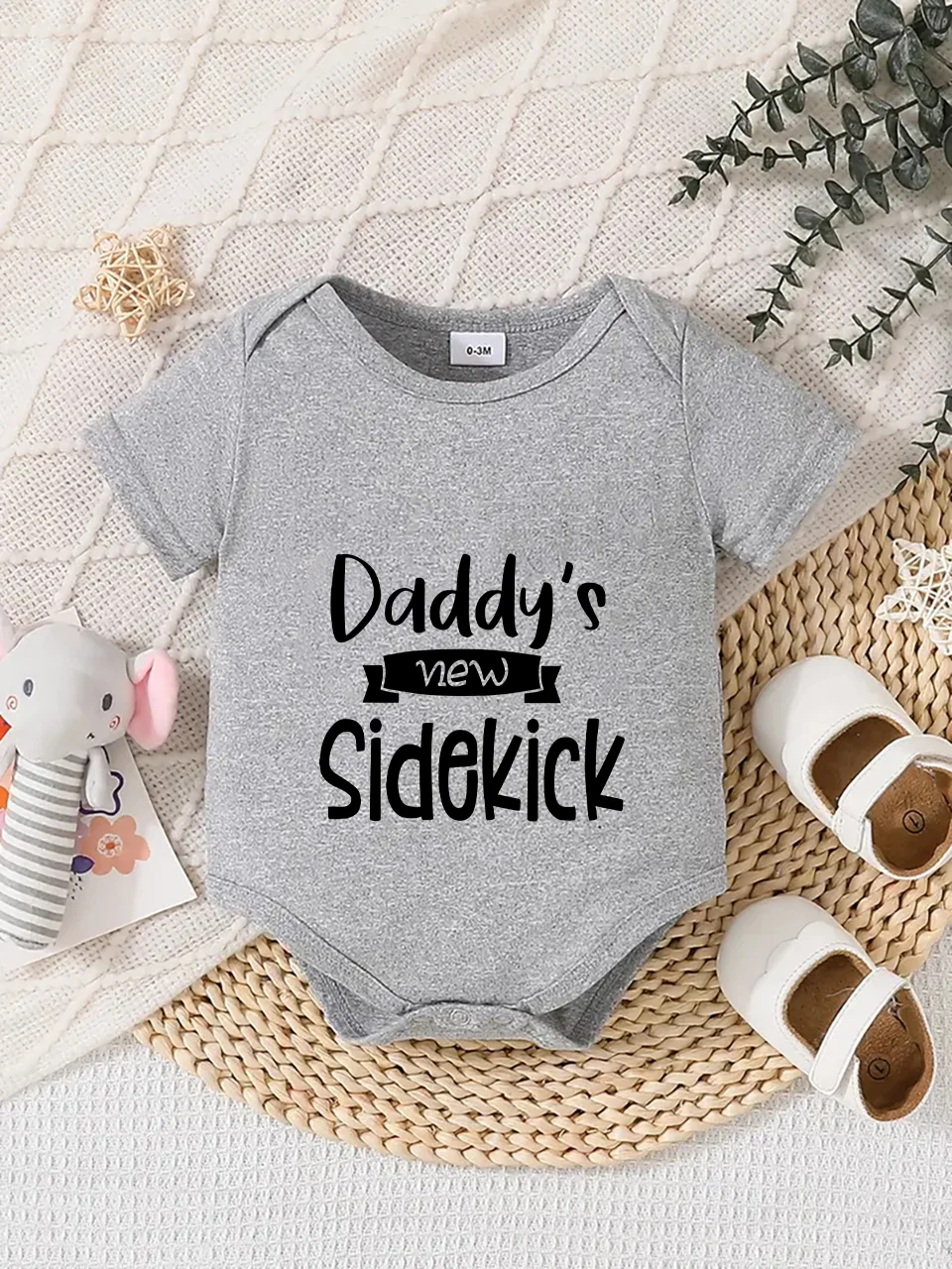Playful letter-printed baby short-sleeve triangle bodysuit. Button closure for easy dressing