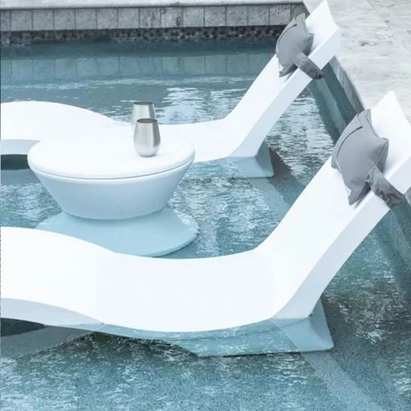 

White fiberglass ergonomic oversized beach loungers swimming pool wet