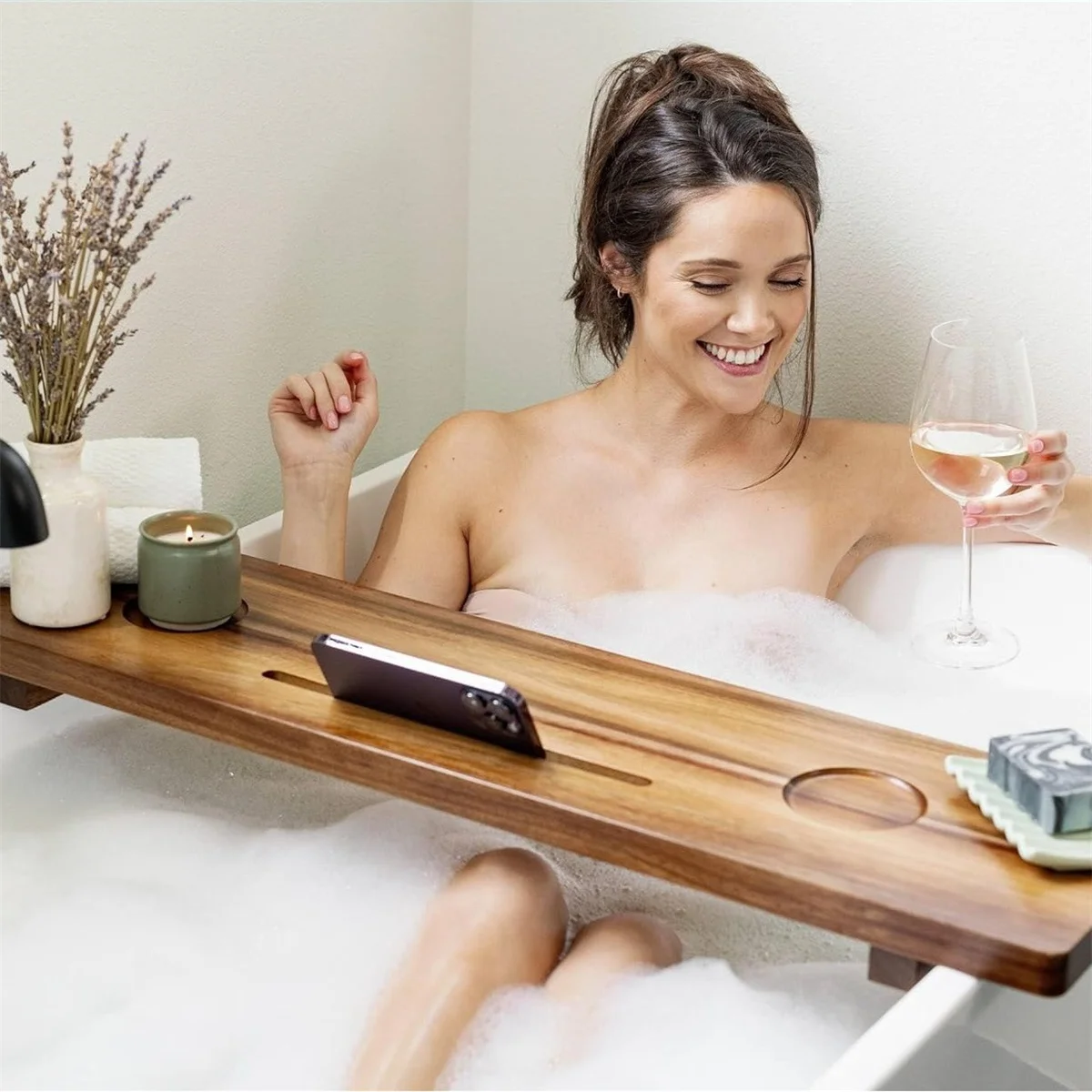 Extendable bathtub tray/shelf for holding mobile phones, tablets, books, and bath supplies while bathing.