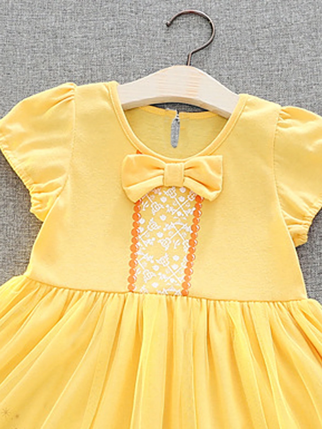 Vibrant yellow princess dress - short sleeves, cute bow decoration, button closure, perfect for girls party occasions and summer