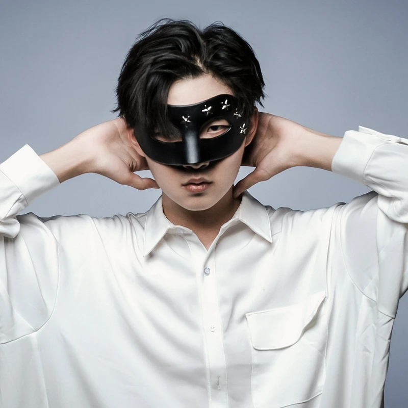 

Man wearing a half-face handmade mask performing a stage show, becoming a popular online figure on Douyin, during the Halloween