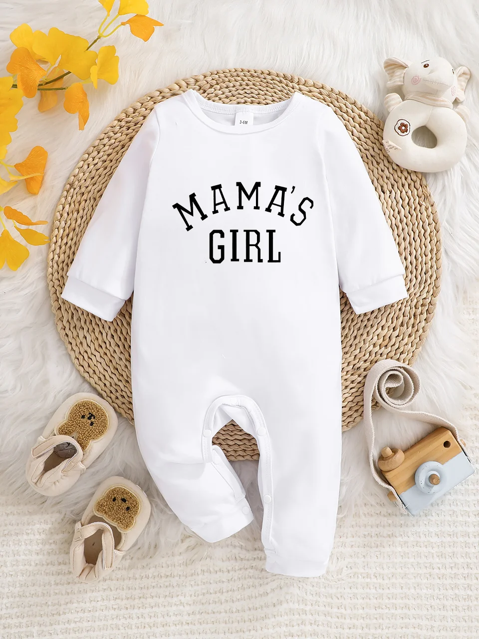 A baby long-sleeved onesie with interesting letter prints. It features a buttoned design for easy putting on and taking off