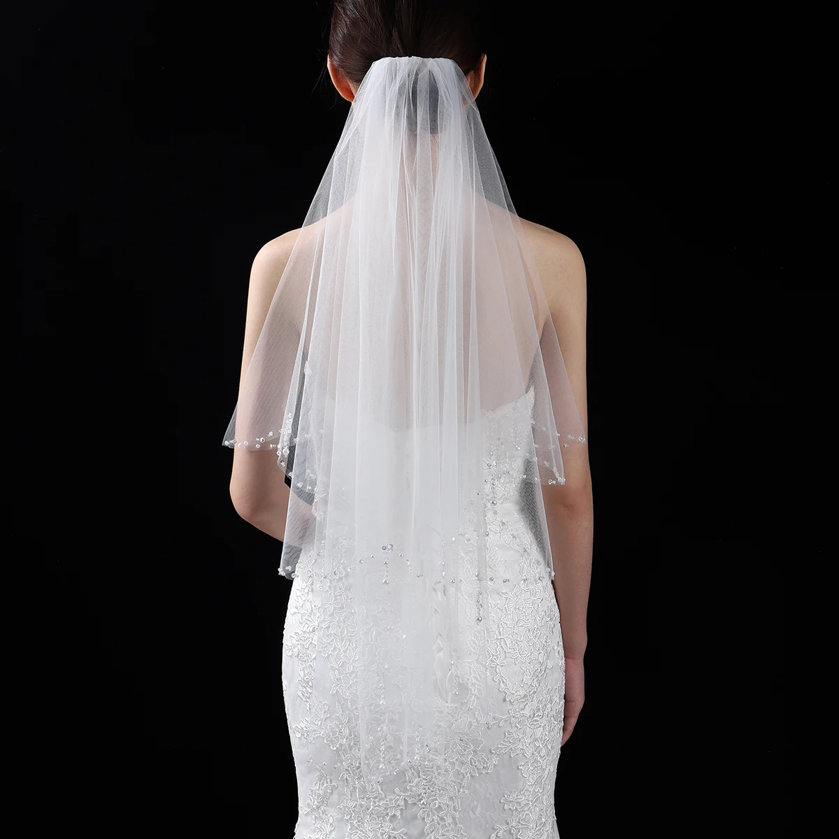 A white elegant bridal veil adorned with beaded waist length veils suitable for women's weddings