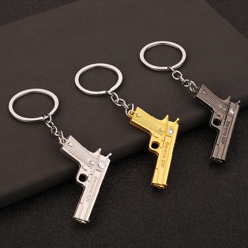 

Mini metal pistol men's car pendant Jedi survival simulation model gun keychain