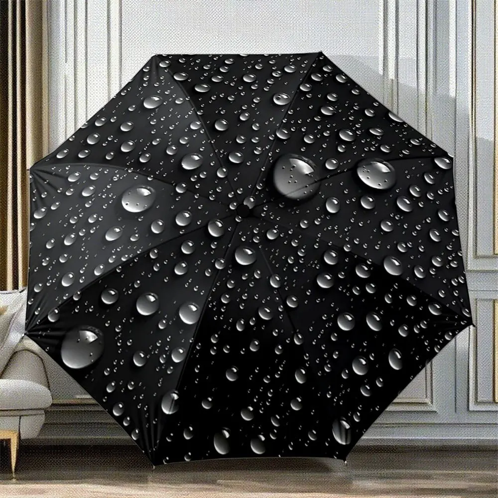

An Automatic Folding Umbrella with Droplets Against a Black Backdrop. Its Portable And Collapsible Design Makes It a Great Cas