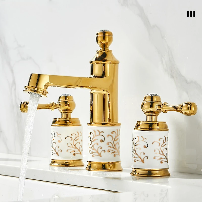 Retro-style, luxury-inspired gold three-hole basin tap with separate hot and cold water handles