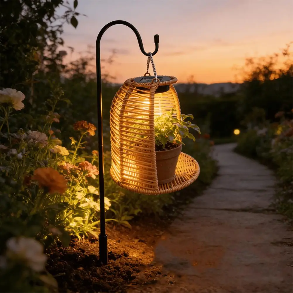 Japandi hand-woven PE rattan solar lantern sitting on a small wooden patio table casting warm light patterns