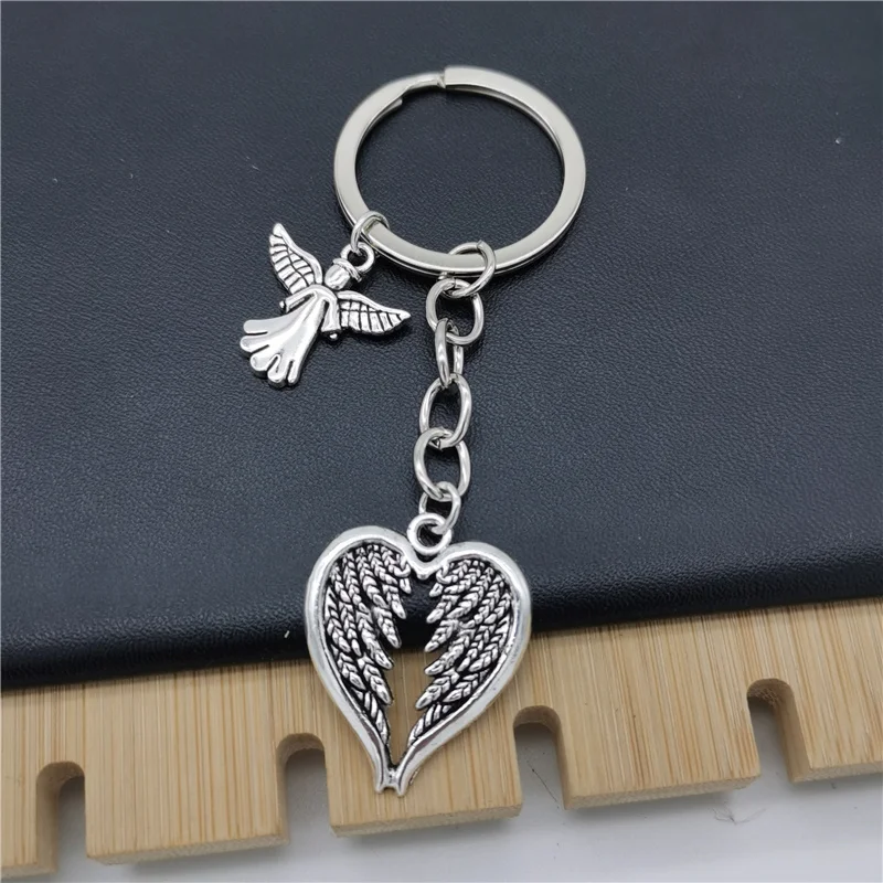 سلسلة مفاتيح Fashion Guardian Angel بتصميم أجنحة على شكل قلب، خفيفة وذكية، يمكن تعليقها على حقائب اليد