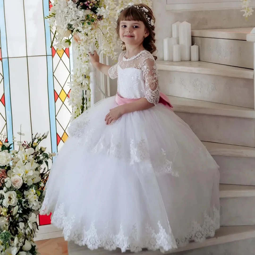 فستان فتاة الزهور البيضاء المخصص مزين بالزهور مع فيونكة وردية نصف كم لحفلات الزفاف وأعياد الميلاد وحفلات التواصل المقدس