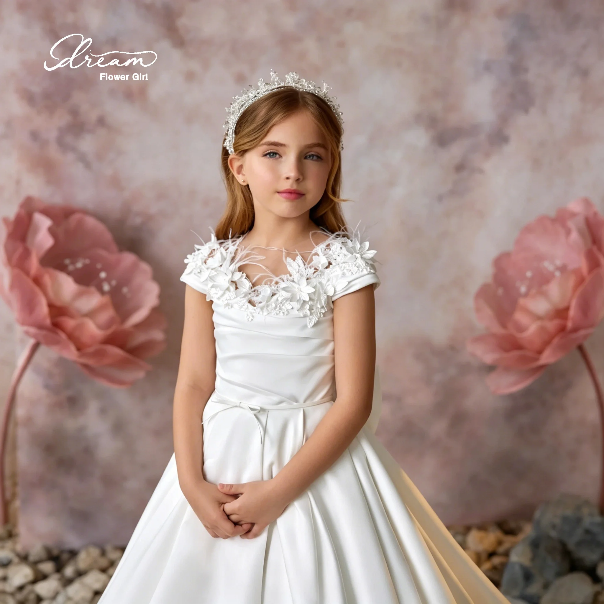 Elegant flower girl's white satin A-line dress, floor-length evening gown, featuring embroidered neckline and bow details.
