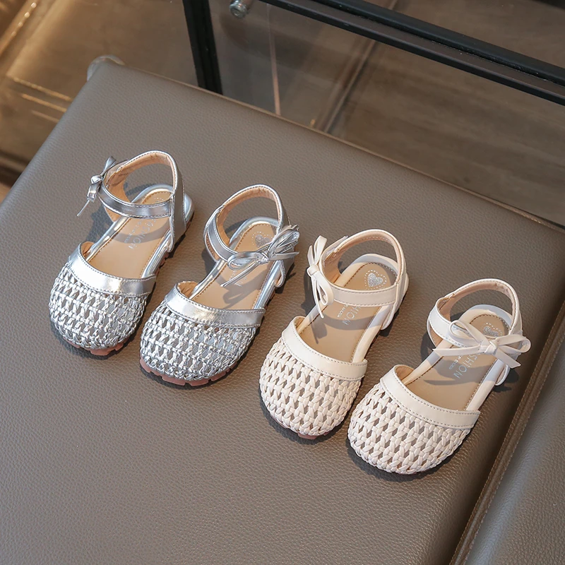 

Детские плетеные сандалии для девочек 2026: Новые летние пляжные туфли в британском ретро-стиле с милым бантом, мягкие, ажурные, элегантные, универсальные