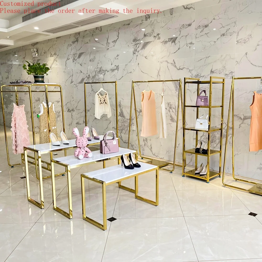 

Custom.Modern Design Metal Side Shiny Gold Retail Garment Store Display Table Golden Clothing Display Racks for Clothes Shop She