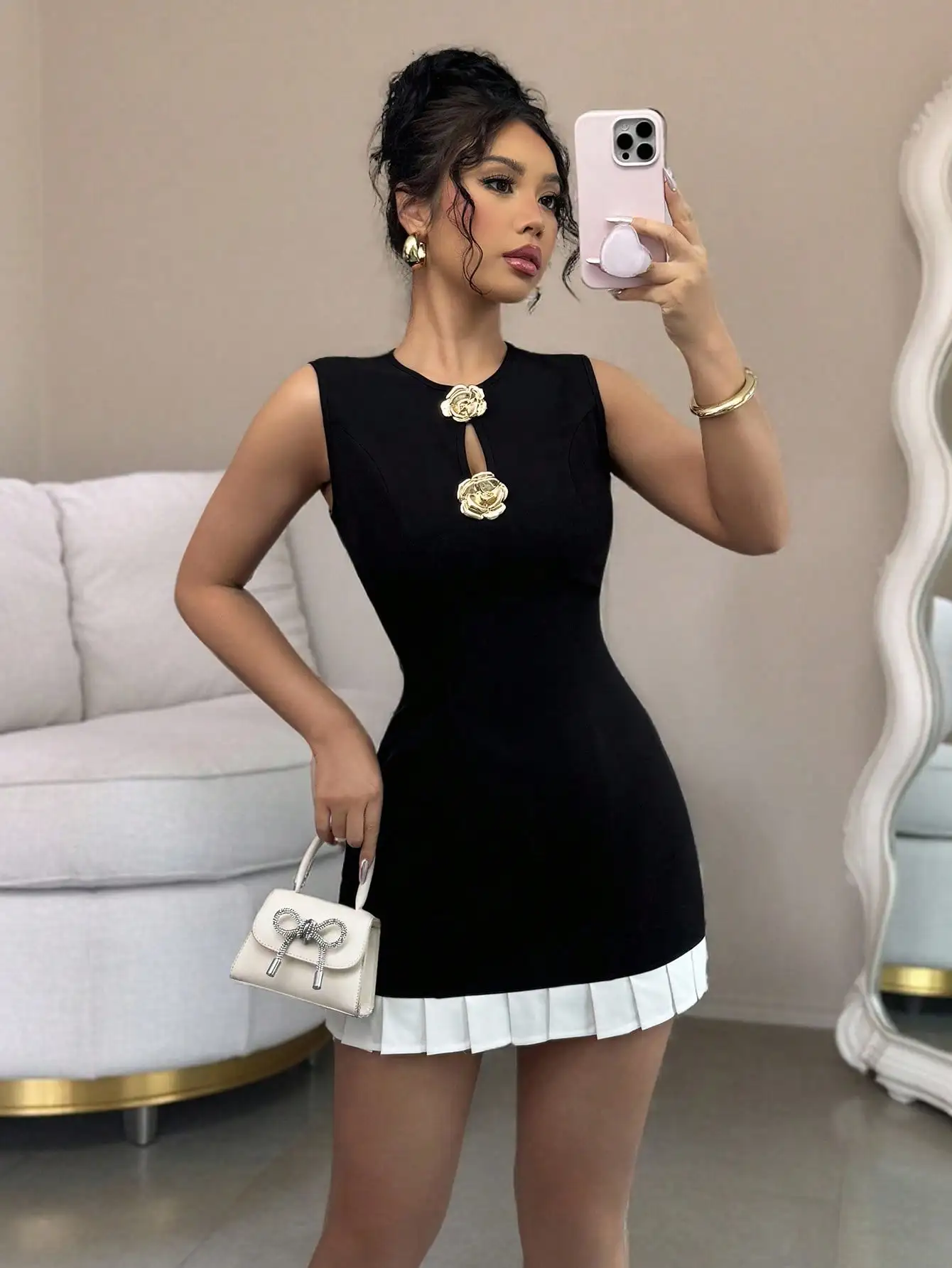 

Black Sleeveless Dress with Gold Floral Embellishments and White Pleated Hem