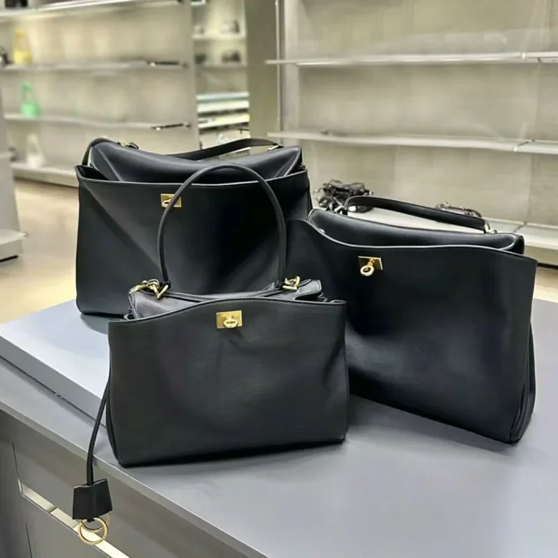 Rodeobag-Bolso de cuero genuino para mujer, bandolera cruzada inclinada, con hebilla de bloqueo, para las axilas, color dorado y negro, novedad