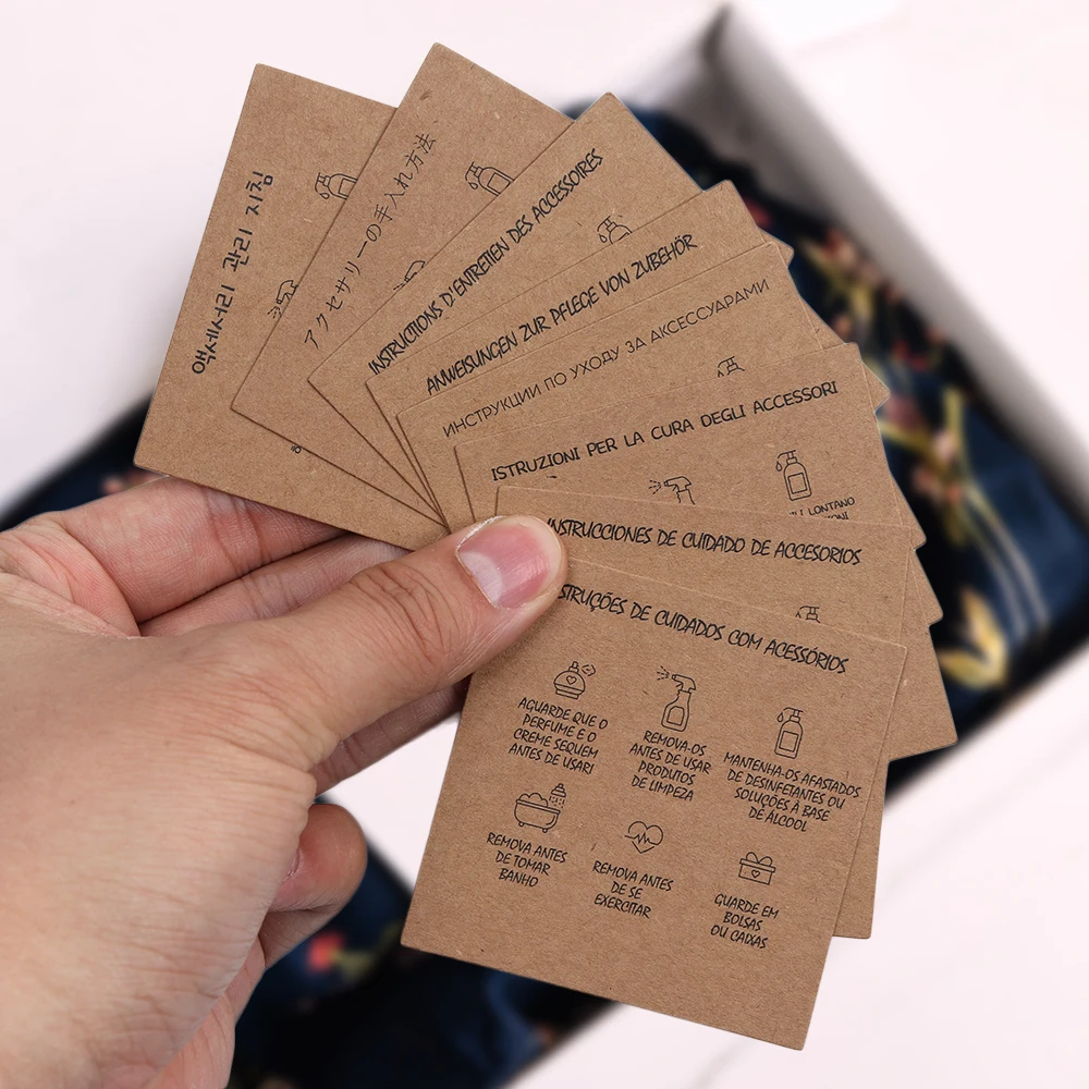 50 Stück 9 Sprachen 6,5 x 6,5 cm quadratisch weiß braun Pflegeanweisungen individuelle Einlage Karte für Schmuck DIY Verpackung liefert Großhandel – Detail 2