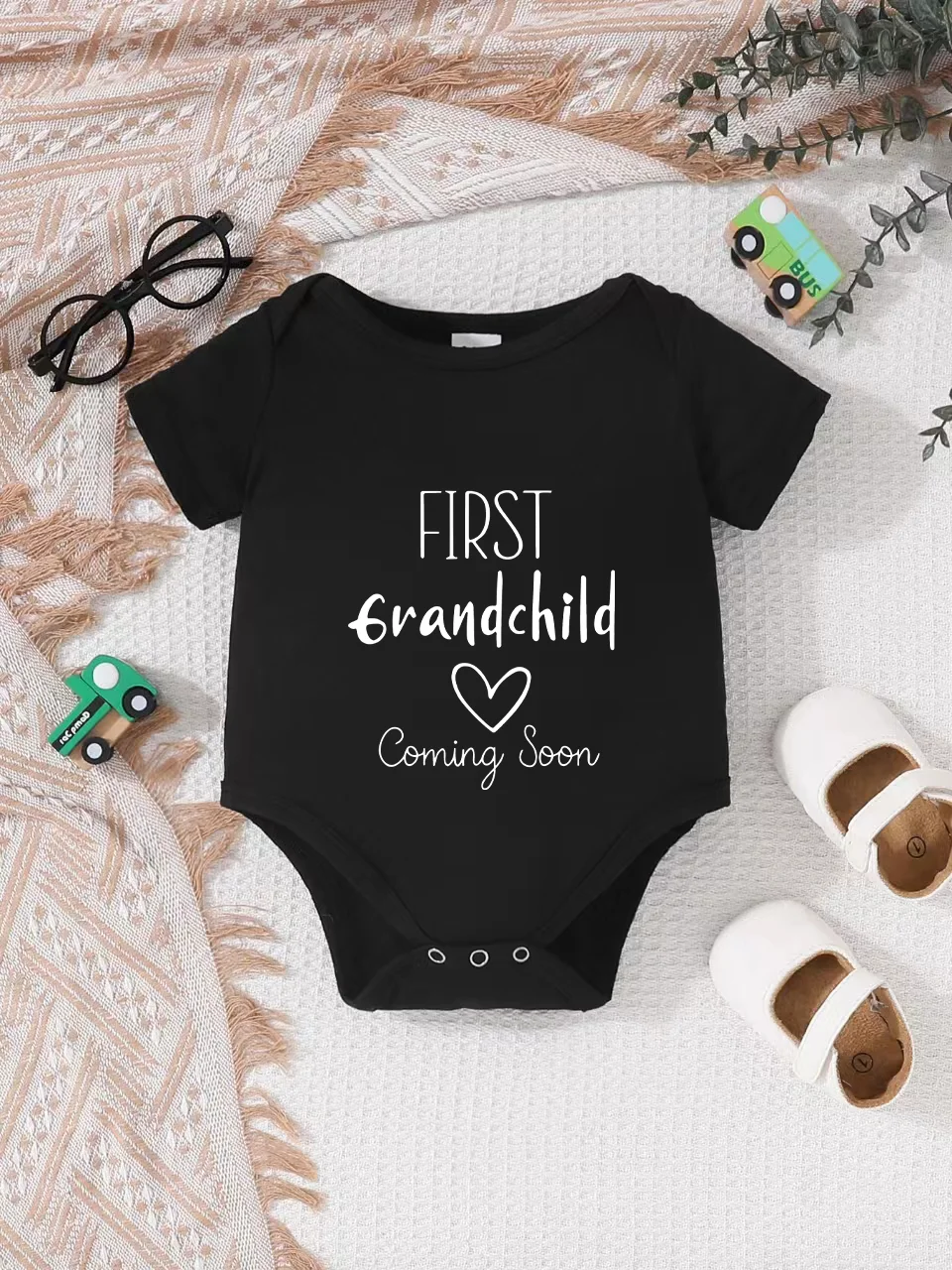 Playful letter-printed baby short-sleeve triangle bodysuit. Button closure for easy dressing