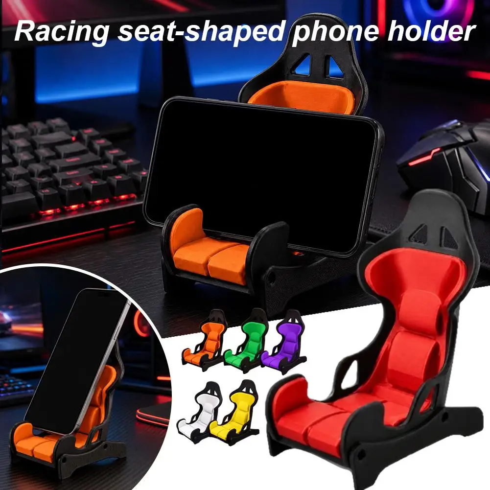 Racing Seat Phone Stand In Red And Black For Office Desk Use With A Bucket Seat Design For Watching Videos And Mobile Gameplay