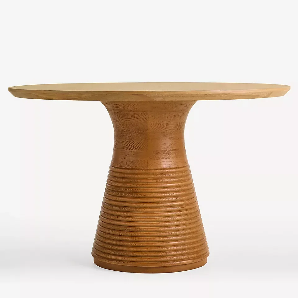 Solid oak round dining table with textured base, suitable for restaurants and cafes