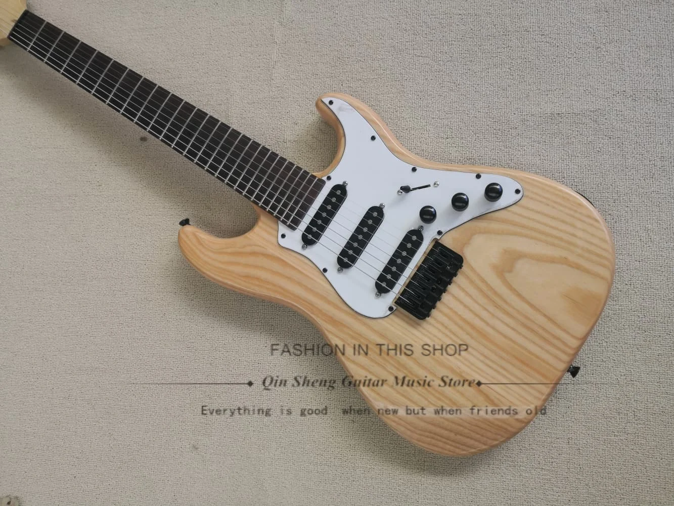 7 strings original color guitar, fixed bridge, ASH wood body, SSS pickups, black tuners, customizable