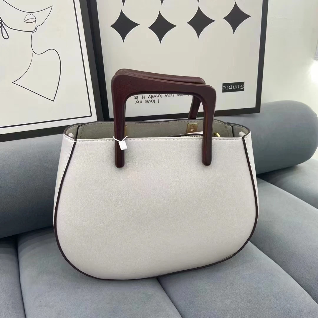 

Designer 2023 new female bag niche design small crooked saddle bag plain cowhide new crossbody bag