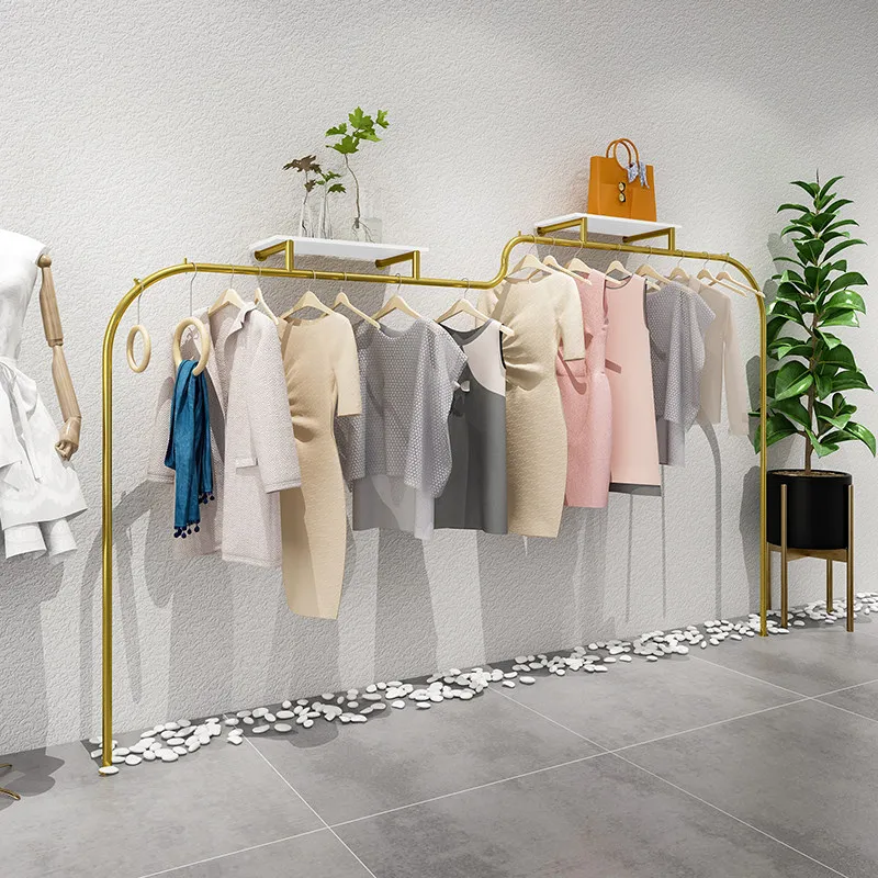 Clothing store display shelves on the wall Stainless steel supports custom hanging clothes shelves Simple and creative women's