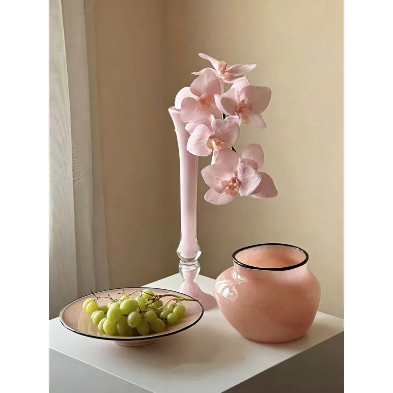 Slender high-stemmed pink glass glass handmade vase with a sophisticated design, niche vintage style ornament