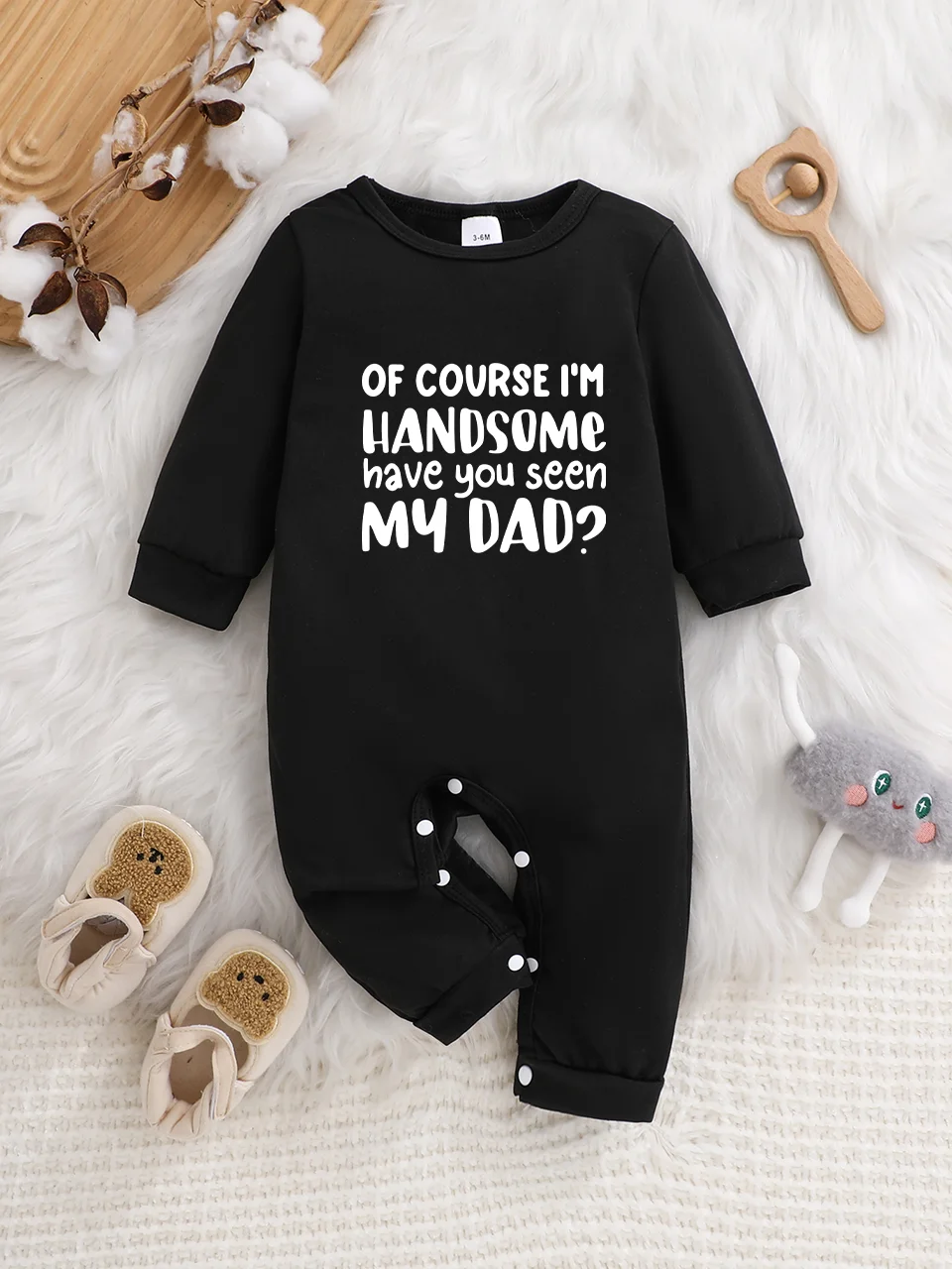 Baby long-sleeved bodysuit with fun letter prints, button design, easy care, suitable for new parents.