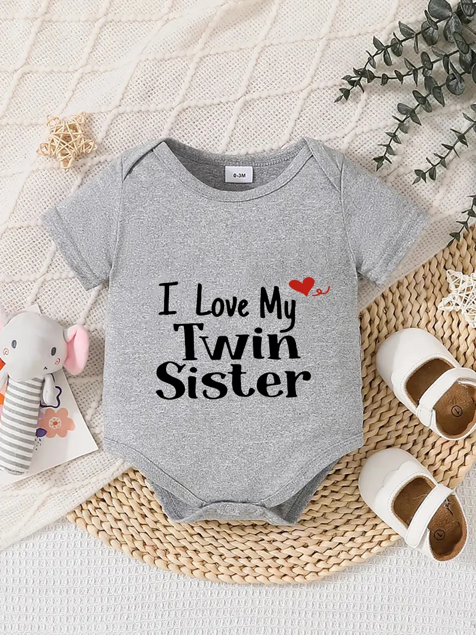 Playful letter-printed baby short-sleeve triangle bodysuit. Button closure for easy dressing, machine washable