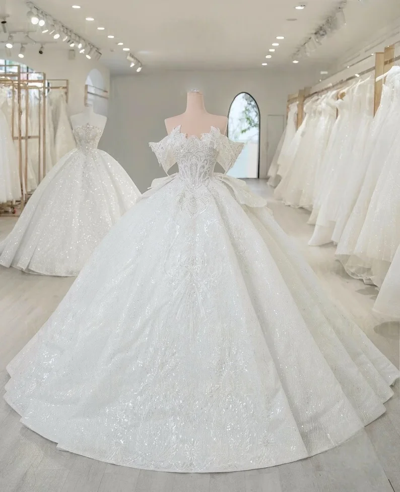 

Customize a Unique 2025 Beaded Off Shoulder Queen Sleeve Sparkling White Ball Gown Paired With Layered Skirts And Shiny Chiffon